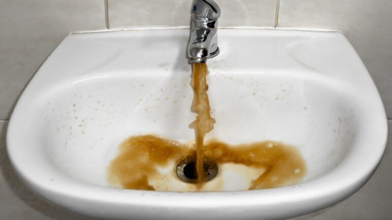 dirty water pouring out of faucet
